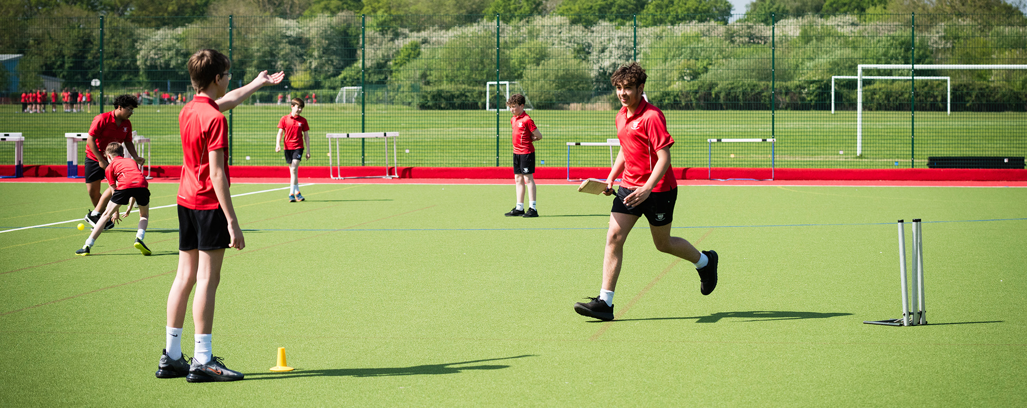 Students playing cricket